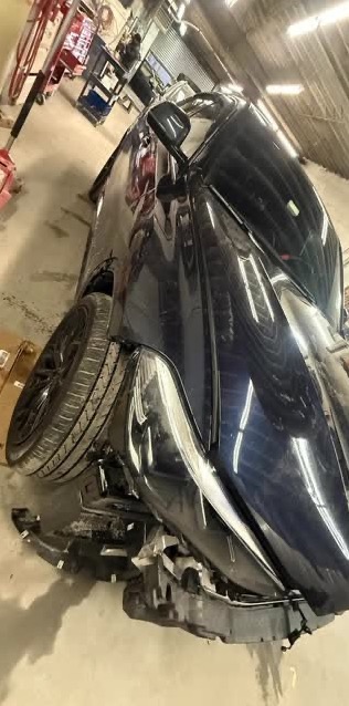 BMW X6 with front-end collision damage in our shop