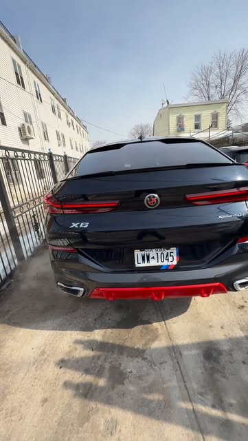 Black BMW X6 customized with red accents