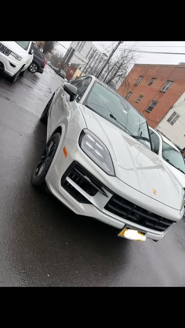 White Porsche Cayenne outside the shop